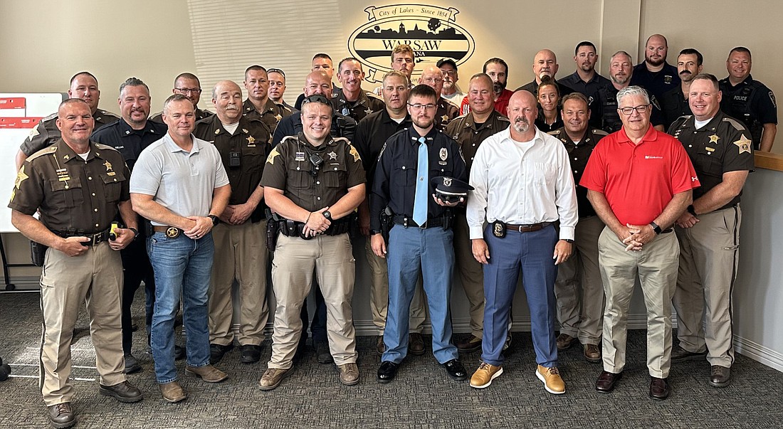 Warsaw Police Department officer Nickolas Shaw (first row, third from right) received the ceremonial oath of office Friday during the Board of Public Works and Safety meeting. He is the son of Kosciusko County Sheriff’s Office Sgt. Jeff Shaw, who was killed in the line of duty in 2009. Attending the ceremony were officers from the WPD and KCSO. Photo by David Slone, Times-Union.