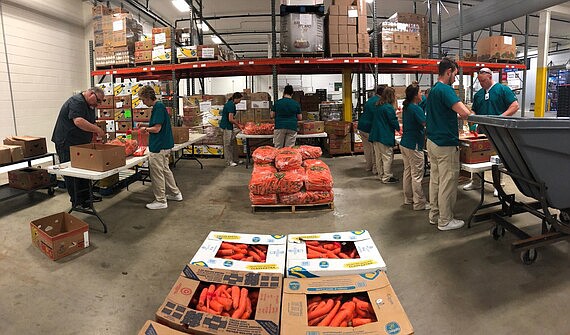 Pictured is an Indiana food bank with volunteers packing carrots for distribution. Photo Provided