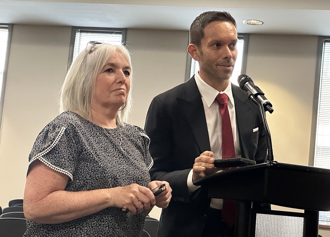 Michael Ryman (R) speaks to the Warsaw Board of Zoning Appeals Monday about his petition to have gravel on the back portion of driveways on McClellan Street. Also pictured is his mother, Vonda Ryman. Photo by David Slone, Times-Union