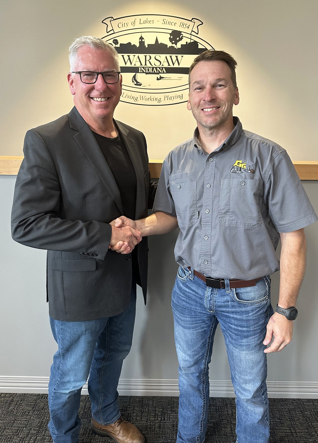 Brandon Schmitt (R) resigned from the Warsaw-Wayne Fire Territory board, effective Monday, July 31, as he returned to being a full-time firefighter. David Allbritten (L) was chosen to replace Schmitt on the board and took the oath of office Tuesday. Photo by David Slone, Times-Union