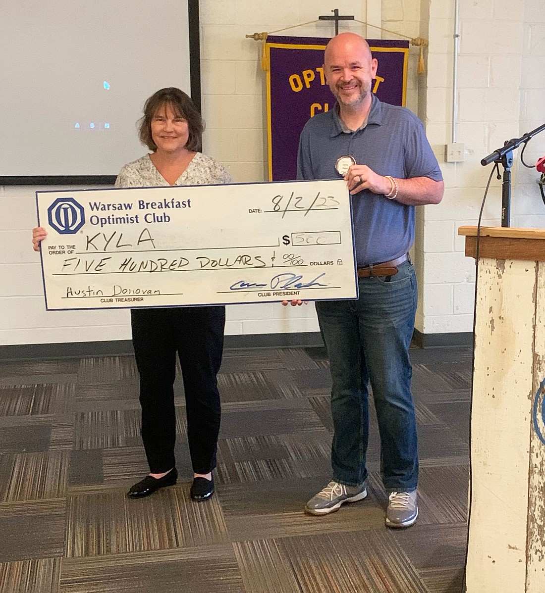 Pictured (L to R) are Cindy Klusman, a representative from Kosciusko Youth Leadership Academy, and Chris Plack, president of the Warsaw Breakfast Optimist Club. Photo Provided.