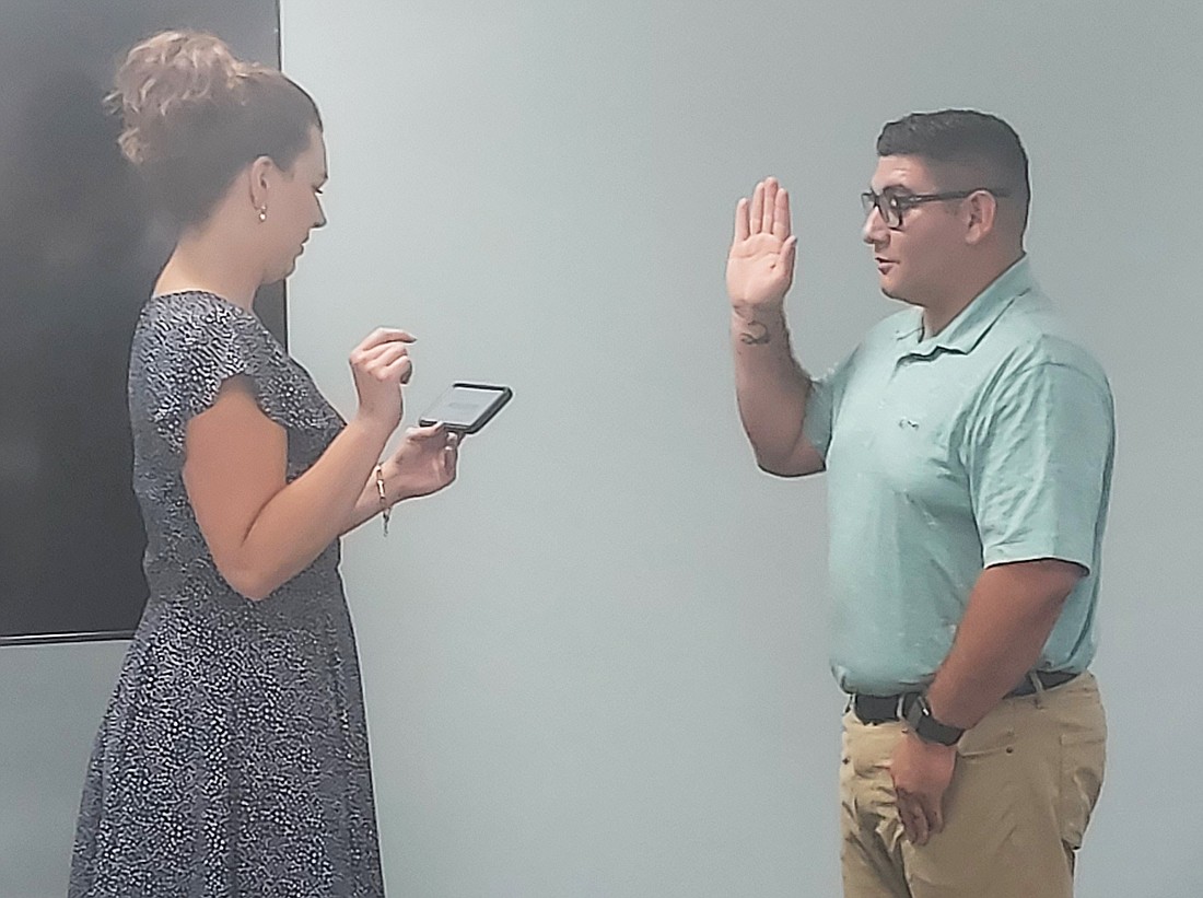 North Webster Clerk-Treasurer Leigh Ann Jessop swears in Raymon Torres as a new police officer for the North Webster Police Department. Photo by Jackie Gorski, Times-Union