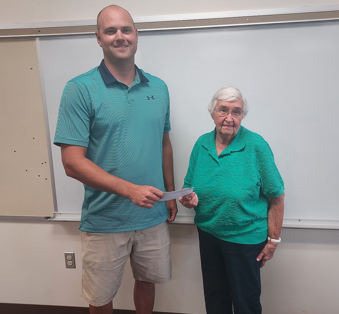 The Mentone Alumni Association donated $1,053 to Tippecanoe Valley School Corporation. Pictured (L to R) are David Lash, school board president, and Alice Keirn, alumni association president. Photo by Jackie Gorski, Times-Union