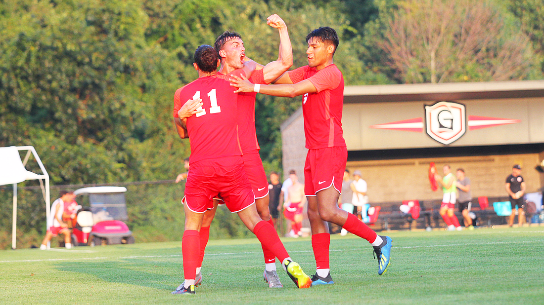 A group of Lancers celebrates during Grace’s 2-0 win against Oklahoma Wesleyan Thursday.