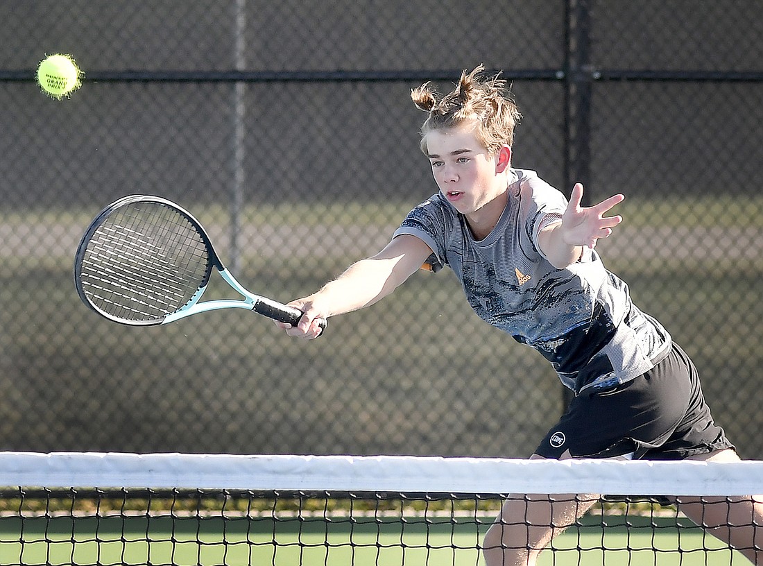 Warsaw sophomore Ted Grandon chases down the ball during his No. 2 singles match. Photo by Gary Nieter