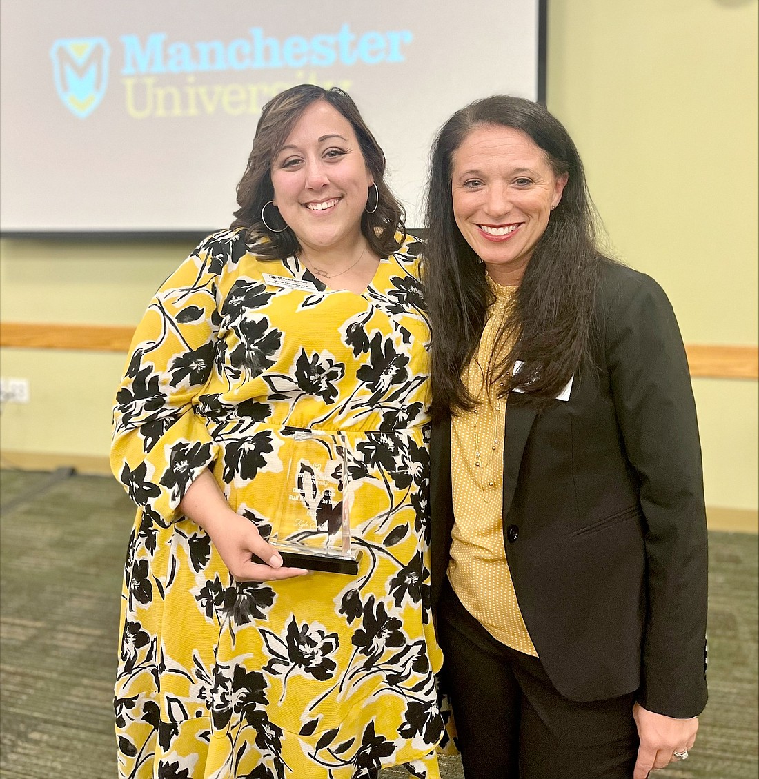 Pictured are Kyle Grubbs (L), 2023 Staff Member of the Year recipient, and Manchester University President Stacy Young (R). Photo Provided