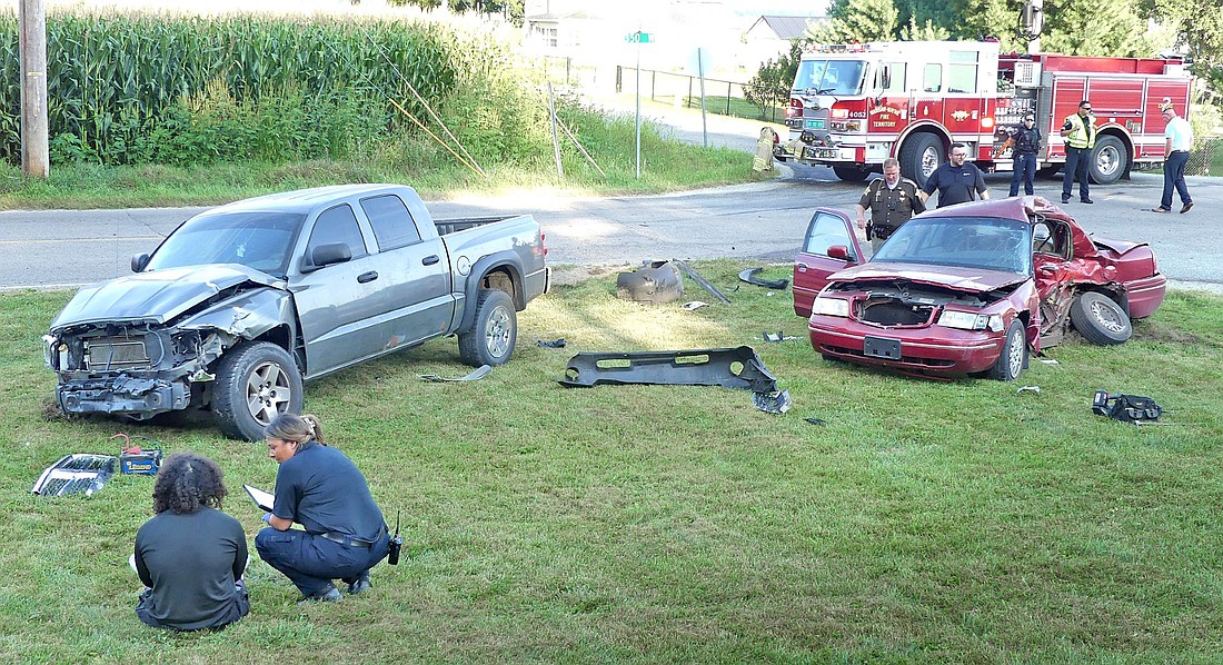 One of the drivers is checked out by a medic after this morning's fatal two-vehicle accident at the intersection of CRs 350W and 200N. Photo by Gary Nieter, Times-Union.