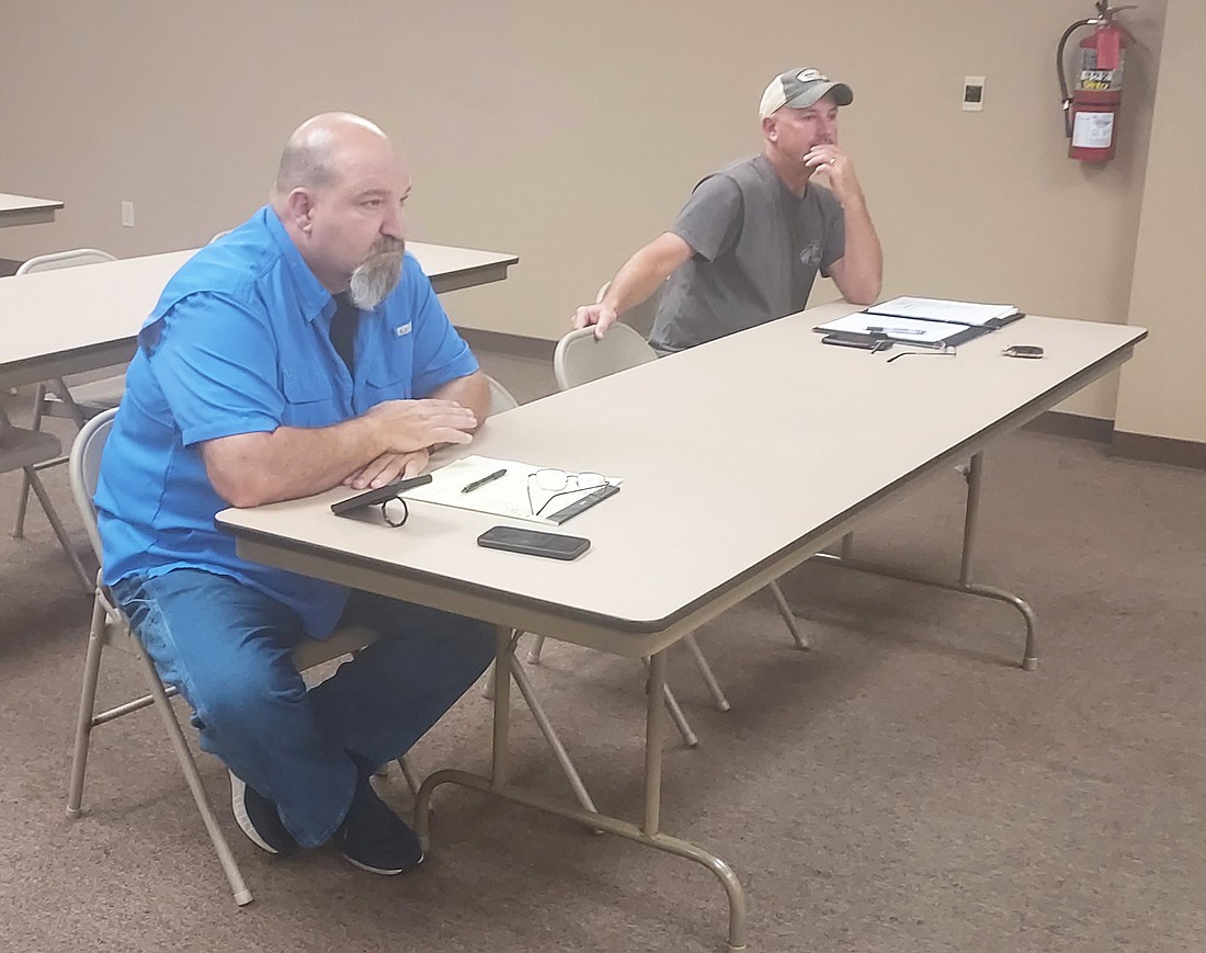 Town Marshal Jim Eads (L) sits in on the Mentone Town Council meeting and listens to Utilities Superintendent Josh Shepherd (R) talk Wednesday. Photo by Jackie Gorski, Times-Union