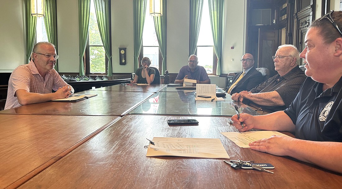 Jerry Parsons (L), vice president and part owner of 201 WM Inc., doing business as West Main Kitchen, 201 W. Main St., Syracuse, answers questions from excise officer April Tackett (R) during Thursday’s Kosciusko County Alcohol Tobacco Commission meeting. Photo by David Slone, Times-Union