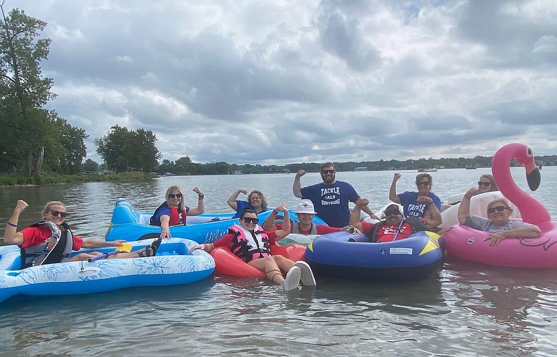 About 600 people attempted to break a Guinness world record for the longest chain of floating inflatables on Saturday on Winona Lake. The event was in honor of Anje Anglin, a former Kosciusko County resident who’s battling Lou Gehrig’s disease or ALS, and meant to bring awareness to the disease. Anglin participated Saturday along with her friend, Kevin Kinnee, who also has the disease, and the family and friends of Brent Lee, who passed away from ALS earlier this year. Shown are Anglin, Kinnee and his family and the family and friends of Lee. Pictured (L to R) are, front: Tamara Kinnee, Abbey Perkins, Kyle Kinnee, Kevin Kinnee and Anglin; back: Hayli Carter, Taylor Lee-Moore, Calvin Lee, Tina Lee and Amanda Fultz. Photo by Leah Sander, InkFreeNews