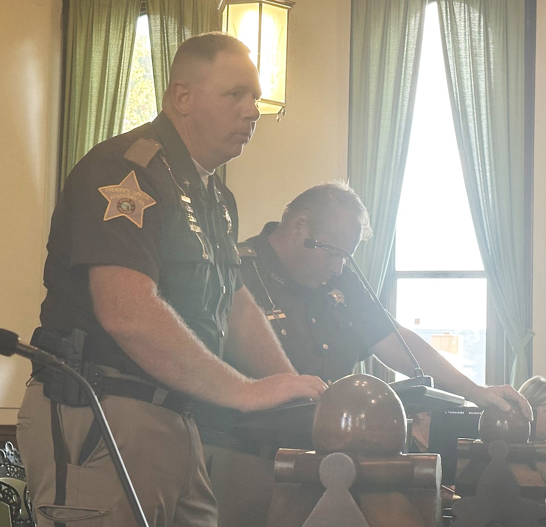 Kosciusko County Sheriff Jim Smith (L) and Chief Deputy Chris McKeand (R) explain the need for four new dispatchers to the county council Thursday. Photo by David Slone, Times-Union