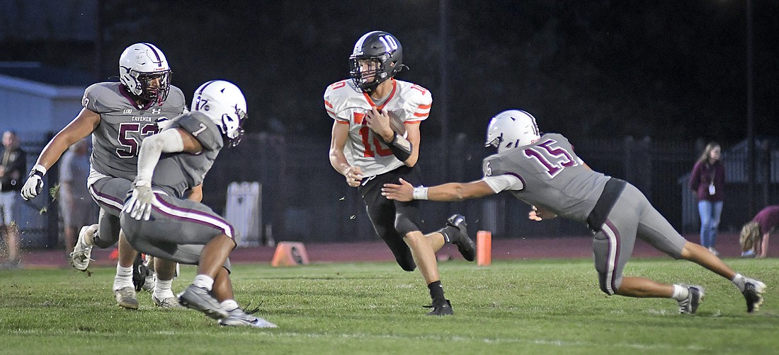 The Mishawaka defense closes in on sophomore Warsaw quarterback Quinton Brock during the second quarter. Photo by Gary Nieter