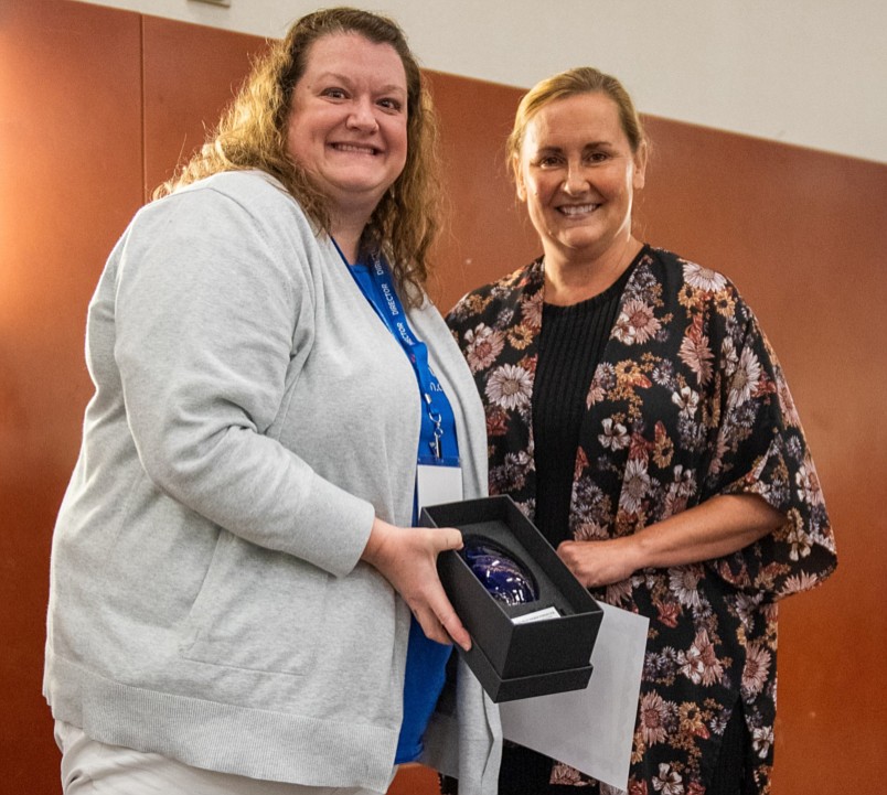 Erin Rowland Jones (L), director of CASA of Kosciusko County, presents the award to Andrea Herschberger (R), Indiana CASA of the Year. Photo Provided.