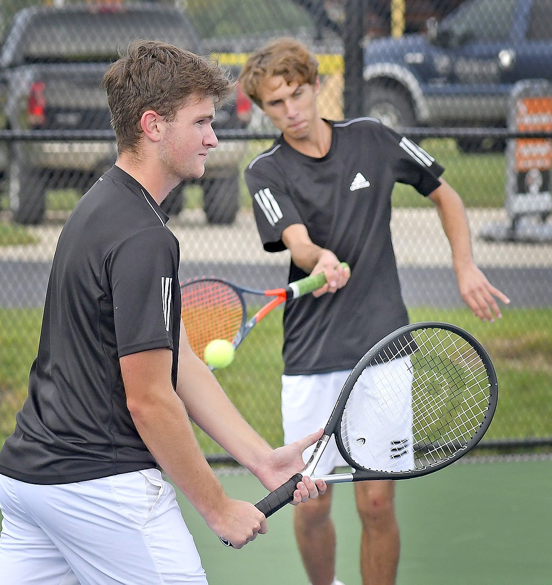 Warsaw senior Patrick Stump (R) returns a volley as classmate and teammate Caleb Smith moves into position for the return during the No. 2 doubles match against Wawasee. Photo by Gary Nieter