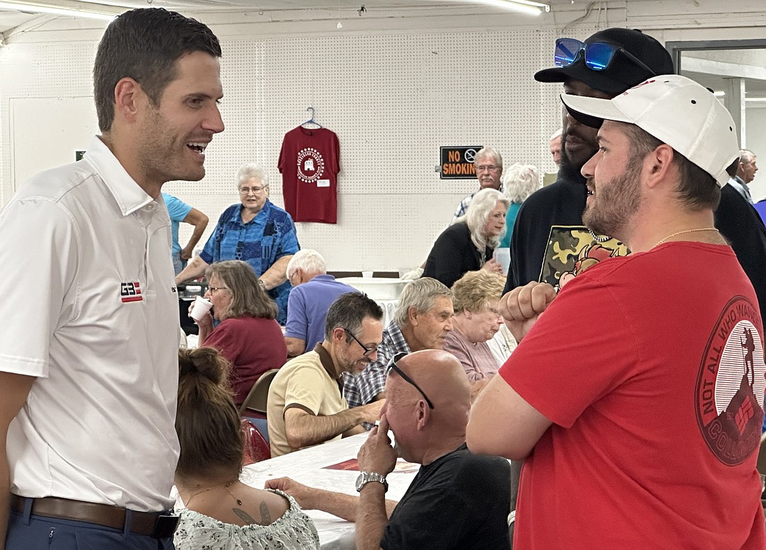 Grant Bucher (L), candidate for Indiana’s 3rd District Congressional seat, talks with Scott Clay and Shawn Brown at the GOP fish fry Wednesday. Photo by David Slone, Times-Union