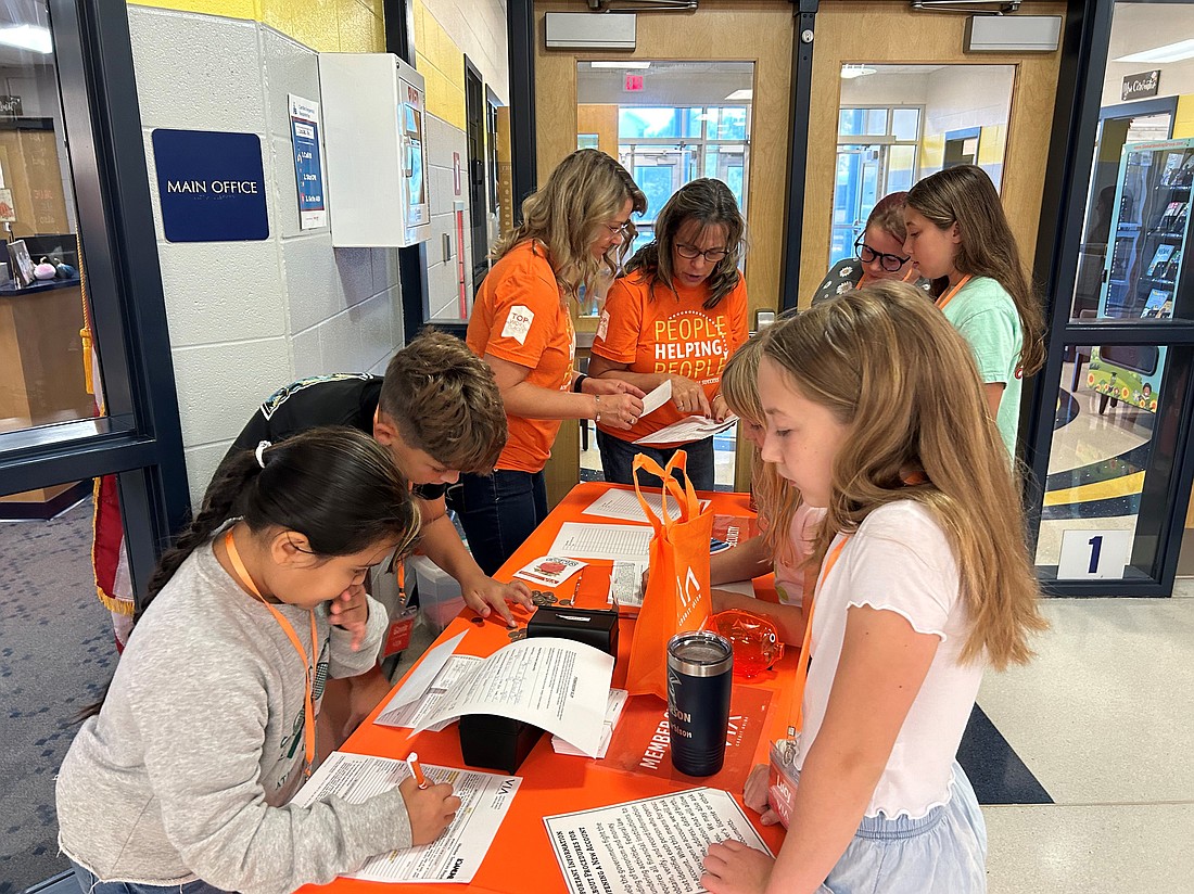 Students are shown opening accounts with Via Credit Union. Photo Provided