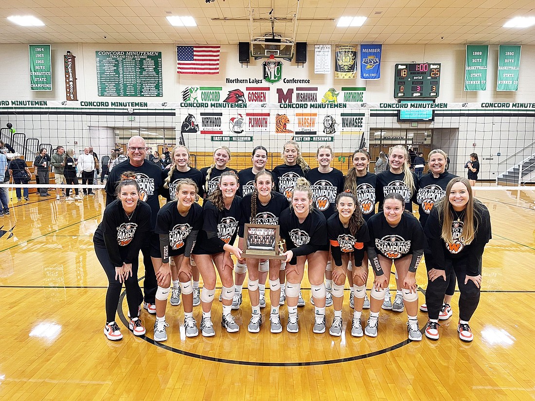 The Warsaw volleyball team celebrates after clinching the Northern Lakes Conference championship outright against Concord on Thursday. Photo provided by Warsaw Tigers