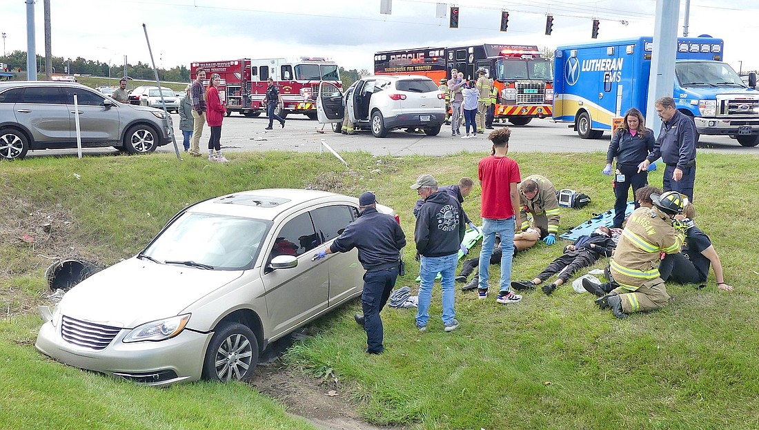 Emergency personnel tend to the victims involved in Sunday afternoon's two-vehicle accident at the intersection of North Detroit Street and CR 250N, Warsaw. Photo by Gary Nieter, Times-Union