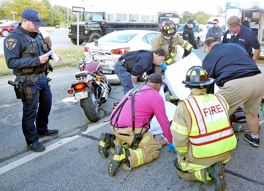 Emergency personnel tend to the motorcyclist involved in Saturday evening's accident in the eastbound lane at the intersection of U.S. 30 and Old 30, Warsaw. Photo by Gary Nieter, Times-Union