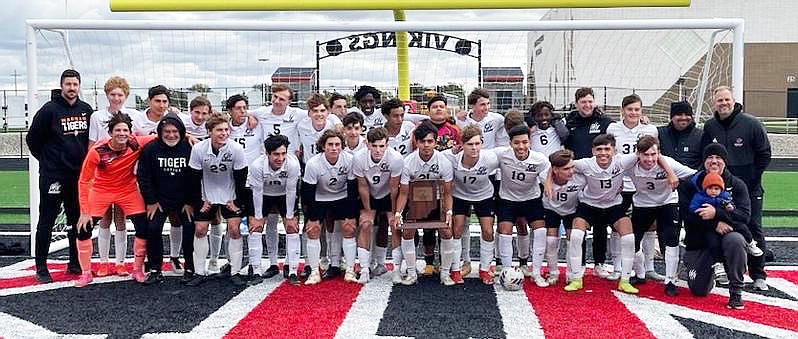 The Warsaw boys soccer team celebrates with its sectional championship trophy, its second in as many years, after defeating Fort Wayne Northrop 2-1 at Huntington North on Saturday.