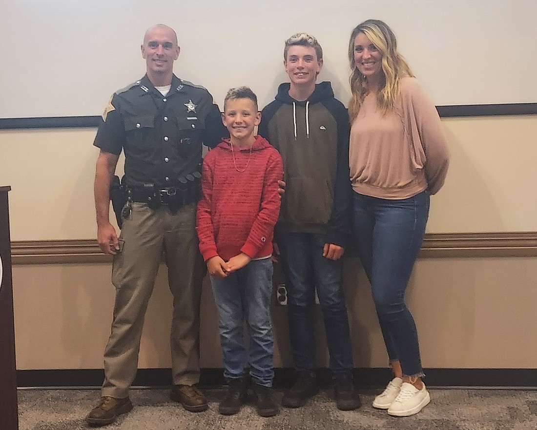 Pictured (L to R) are Joel Popenfoose, school resource officer for Leesburg, Claypool and Madison elementaries, with sons Harrison and Hunter and wife Jessica. Photo by Jackie Gorski, Times-Union