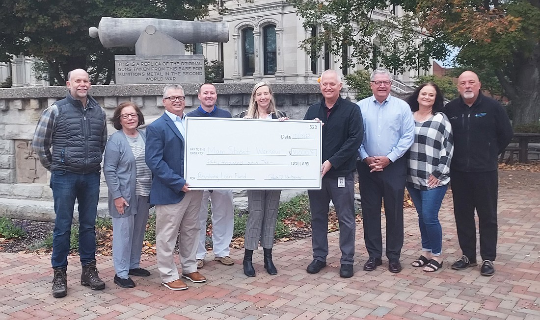 Pictured (L to R) are Kosciusko County Commissioner Cary Groninger, Main Street Warsaw (MSW) Board; Warsaw City Councilwoman Cindy Dobbins, MSW Board; Rob Parker, executive director of MSW; Nathan Conley, MSW Board; Paula Montgomery, LSC Print Solutions; Jon Pierog, LSC Print Solutions; Warsaw Mayor Joe Thallemer; Juli Eckel, MSW Board; and Scott Wiley, MSW member relations manager. Photo by Jackie Gorski, Times-Union