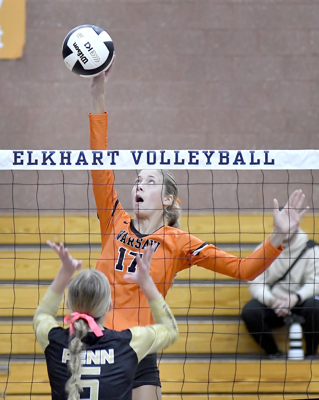 Junior Allison Chapman of Warsaw reaches well above the net to make a kill during Saturday night's sectional championship match against Penn. Photo by Gary Nieter