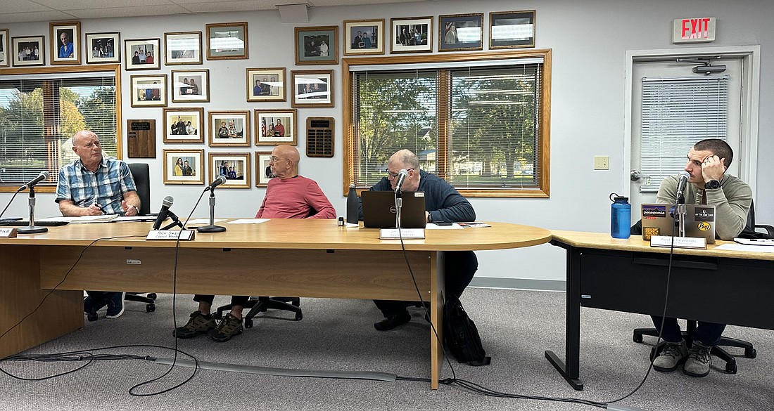 Winona Lake Town Manager Craig Allebach (L) explains the need for a motion to approve the council president and vice president and clerk-treasurer to be signatories for the town’s bank accounts to (L to R) Council President Rick Swaim and members Jim Lancaster and Austin Reynolds. Photo by David Slone, Times-Union