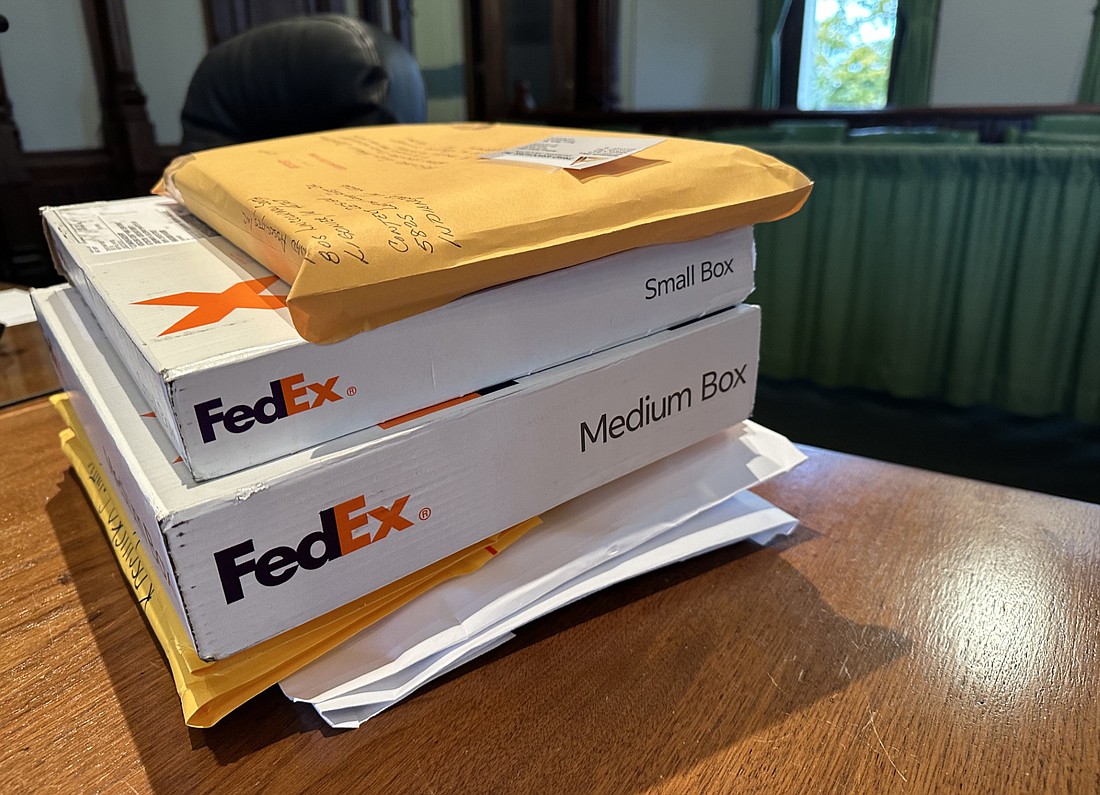 The stack of bids for the countywide blueways and greenways master plan and Chinworth greenway (also known as the Lake City greenway) extension design sit on the table Thursday before they’re opened at the Kosciusko County Parks and Recreation Board meeting. Photo by David Slone, Times-Union