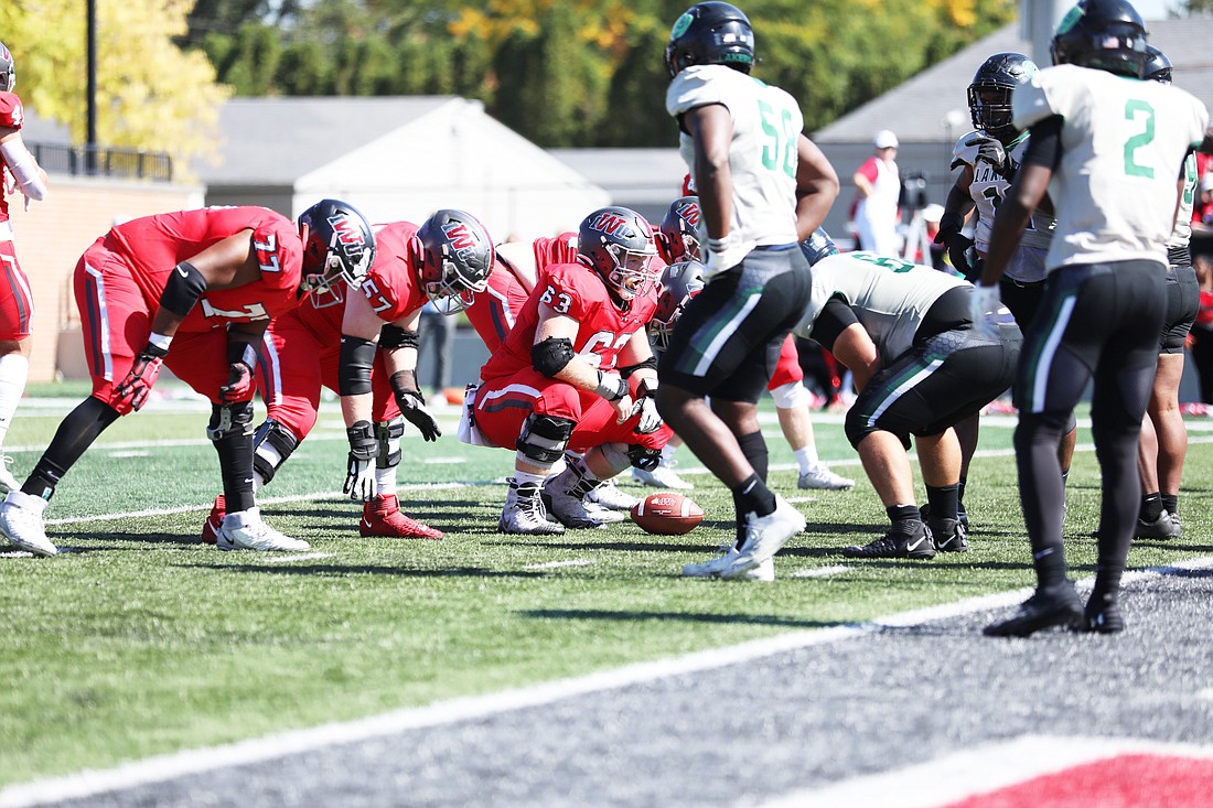 Indiana Wesleyan offensive lineman Isaiah Courtois (#77) lines up as his team prepares for a goal line play. Courtois was a leader on the offensive line the last time Warsaw took down Carroll in the playoffs. Photo provided by Indiana Wesleyan.