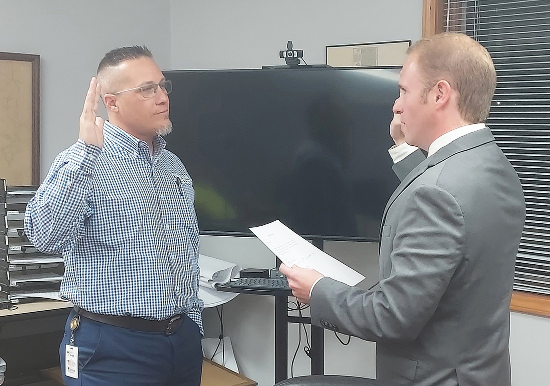 Kosciusko County Republican Central Committee Secretary Austin Rovenstine (R) swears in Barry Andrew (L) as the new member of the Winona Lake Town Council. Photo by Jackie Gorski, Times-Union