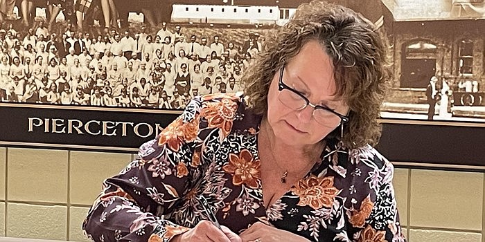 Pierceton Town Council Vice President Janet Castle signs paperwork during Monday’s meeting. Photo by Liz Shepherd, InkFreeNews