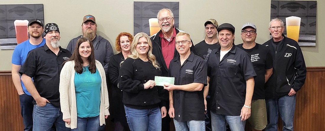 Pictured are Robert Breske, Eric Jacko, Linda Jacko, Nate White, Valle Kincaid, CCS Director of Development Kiira Churchill, CCS Executive Director Randy Polston, Kettleheads President Jason Rich, Calvin Maxwell, Brian Kincaid, Brian Sager and Cliff Hill. Photo Provided.