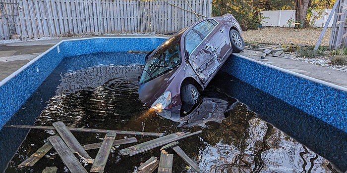 A police pursuit ended when the driver of a 2006 Buick Lucerne, Geoffrey E. Riddle, 35, of Etna Green, hit a wooden privacy fence and entered an in-ground pool at 401 S. Rowland Ave., Leesburg, Thursday morning. Photo Provided by Nappanee Police Department