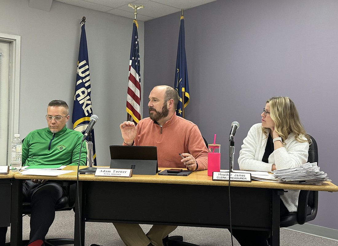 Winona Lake town attorney Adam Turner explains a point in the Designated Outdoor Refreshment Area (DORA) ordinance to the town council Tuesday night. To his right is Councilman Barry Andrew, and to his left is Clerk-Treasurer Heather James. Photo by David Slone, Times-Union