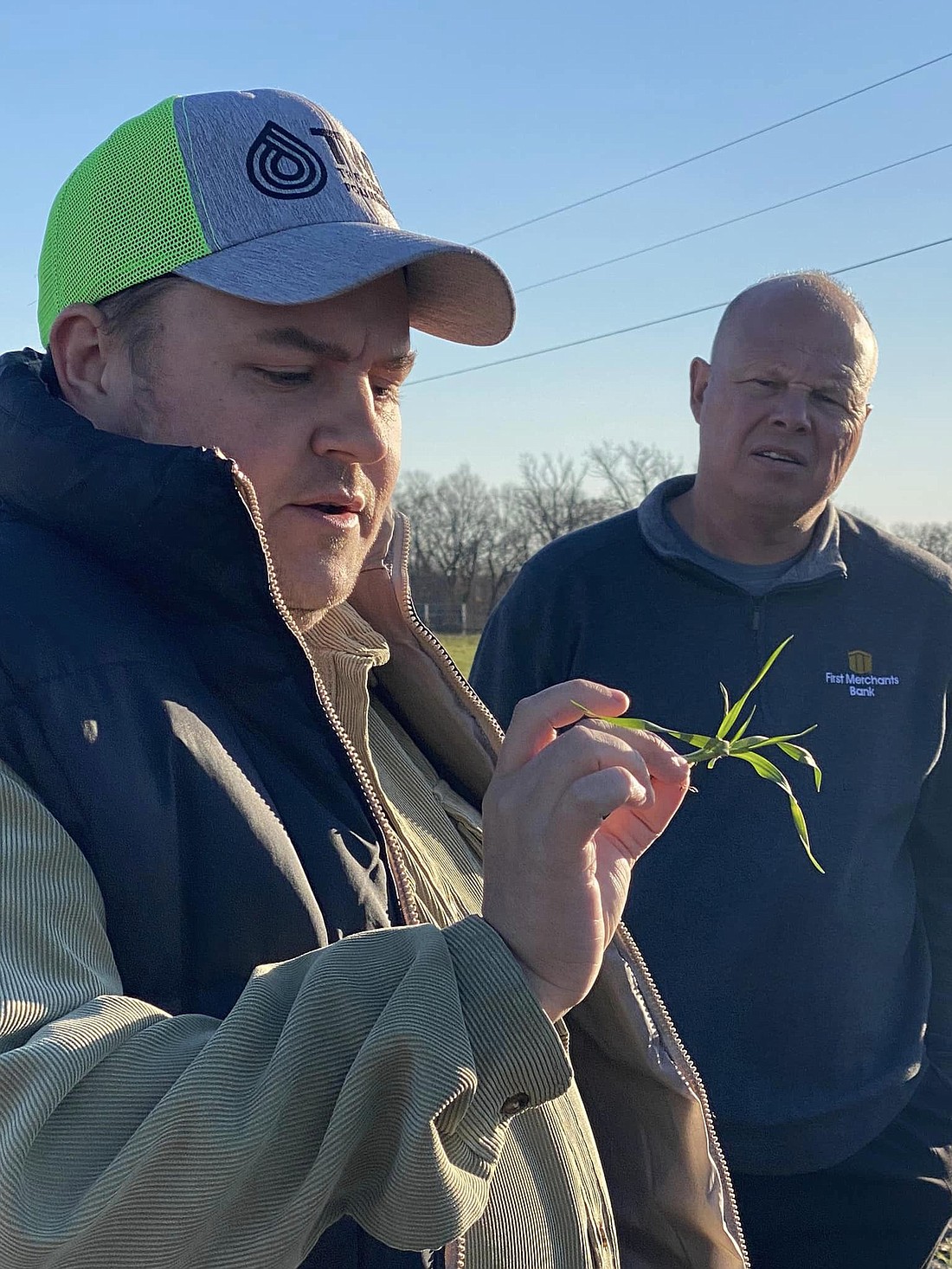 The Watershed Foundation's watershed conservationist Brad Clayton holds a tiny cereal rye sprout, discussing the benefits of cover crops. Photo provided.