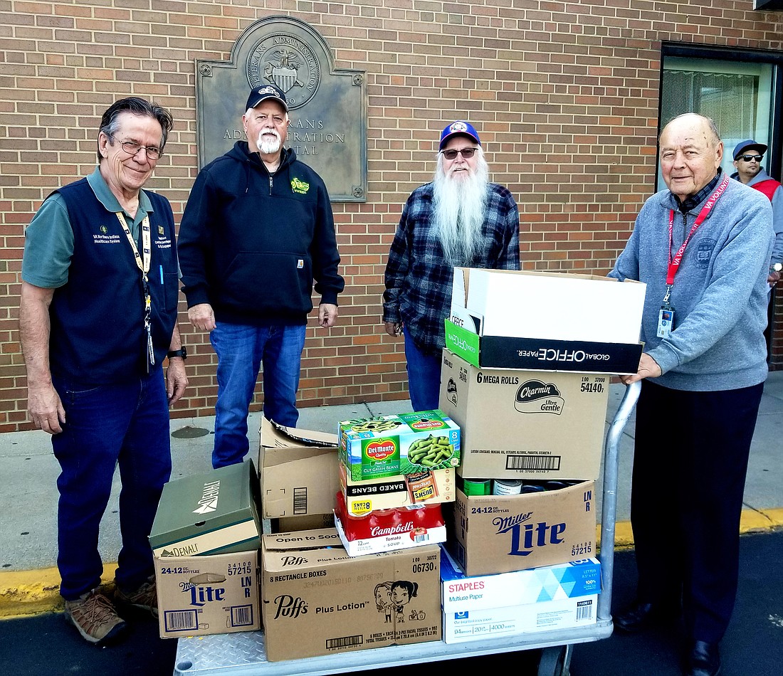 On Nov. 16, 2023, members of the Warsaw VFW Post 1126 and the Auxiliary donated approximately 300 pounds of food to the VA Hospital Food Bank in Fort Wayne. Pictured are Roy, VA representative; Bryan Mendenhall, VFW Riders president; Kirby LeMond, VFW Auxiliary president; and Dave, VA representative. Photo provided.