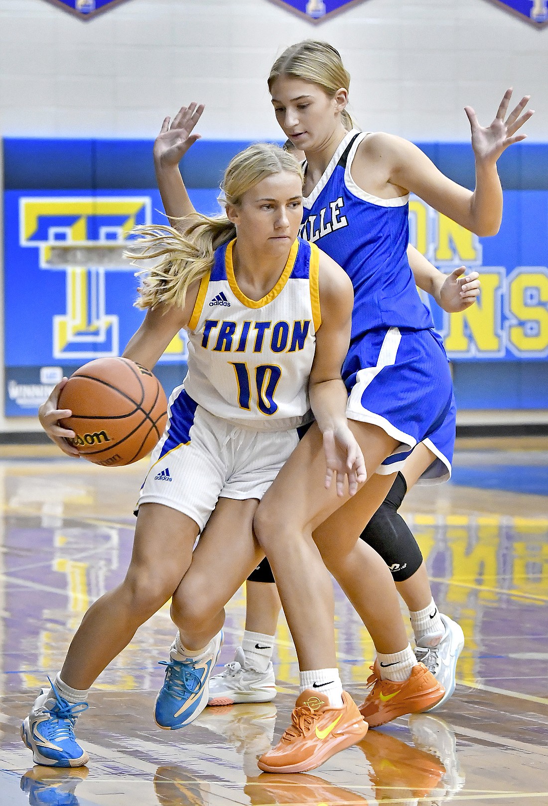 Sophomore Sierra Hawley of Triton takes a knee to the thigh while bringing the ball upcourt during Wednesday night's home game against LaVille. Photo by Gary Nieter