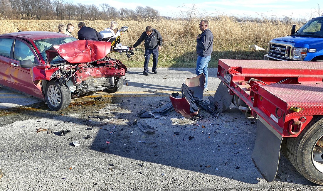 The driver of the 2011 Ford Focus is transported to an ambulance after Thursday afternoon's rear-end collision with a parked semi along CR 300E, north of CR 200N. The accident happened at about 1:55 p.m. in front of 19 EMS C23 Lane, Warsaw, according to Kosciusko County Sheriff’s Office Public Information Officer Sgt. Doug Light. Photo by Gary Nieter, Times-Union