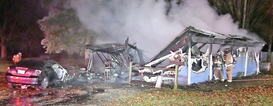 Firefighters had their hands full with a home fire on South First Street in Pierceton Saturday night. Photo by Gary Nieter, Times-Union