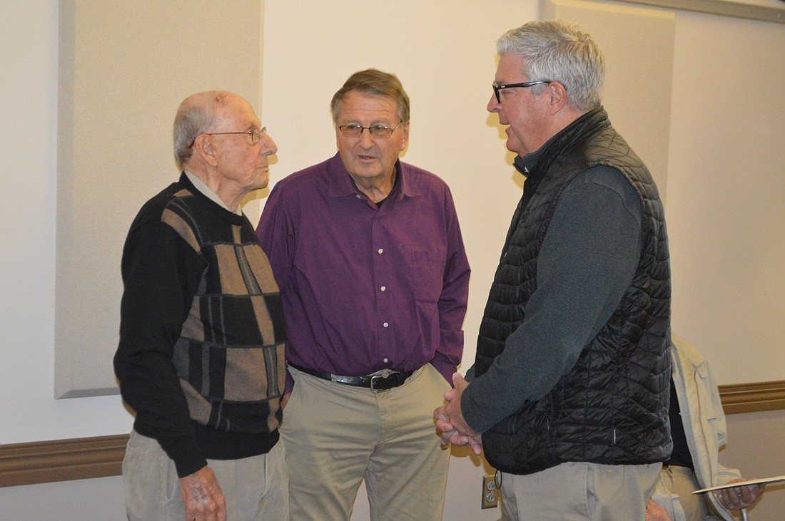 Warsaw Mayor Joe Thallemer (R) talks to Bob Gast (L) and Dave Kintzel (C) during Gast’s 100th birthday celebration in March 2022. Photo by David Slone, Times-Union