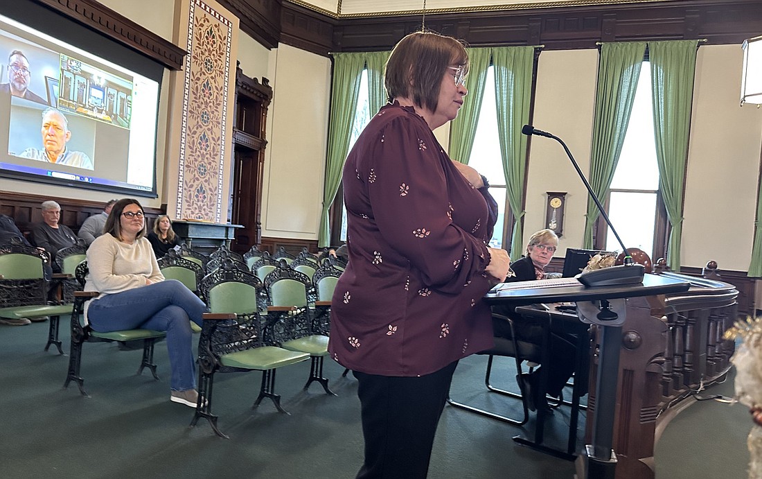 County Assessor Gail Chapman (standing at podium) talks to the Kosciusko County Commissioners Tuesday about commercial-industrial assessments. Sitting behind her is Jennifer Spyres, who will be supervising the commercial-industrial assessment department in the assessor’s office. Photo by David Slone, Times-Union