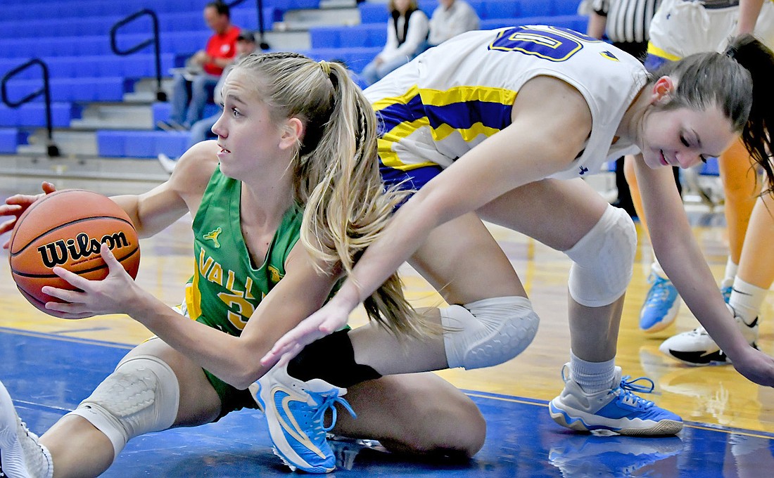 Tippecanoe Valley senior Chesnee Miller looks for an open teammate after grabbing a loose ball from Triton's Jenna Bules. Photo by Gary Nieter