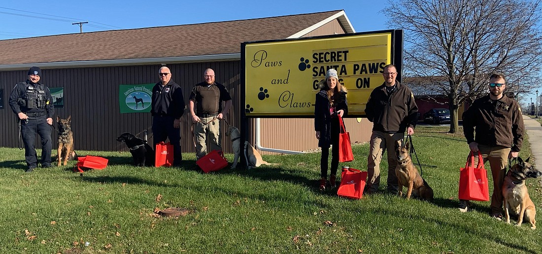 Pictured (L to R) are officer Clayton Reider and K9 Red, Warsaw Police Department; Fire Marshal Joe Fretz and K9 Raven, Warsaw Fire Department; officer Caleb Snyder and K9 Buck, Kosciusko County Sheriff's Department; Melissa Rone, Paws and Claws; officer Travis Shively and K9 Blue, KCSO; and officer Kyle Denton and K9 Axel, KCSO. Photo Provided.