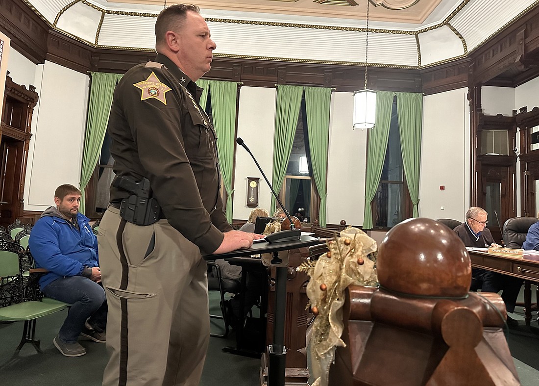 Kosciusko County Sheriff Jim Smith (standing) went before the County Council Thursday for his 2024 salary contract, while local attorney Travis McConnell (sitting behind Smith) was there to make the council aware of problems at Pierceton Woods Academy. Photo by David Slone, Times-Union