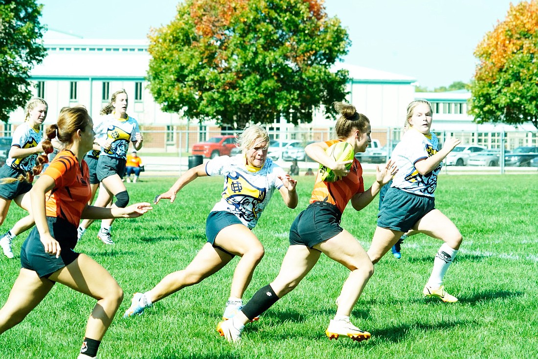 Warsaw senior Mia Blocher (holding ball) finds a gap between defenders as she races past them. Photo by Jasun Blocher