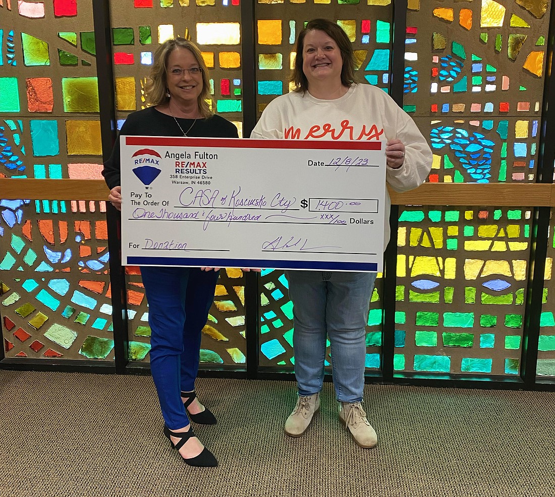 REALTOR Angela Fulton (L) presents a check to Court Appointed Special Advocates Executive Director Erin Rowland Jones. Photo Provided