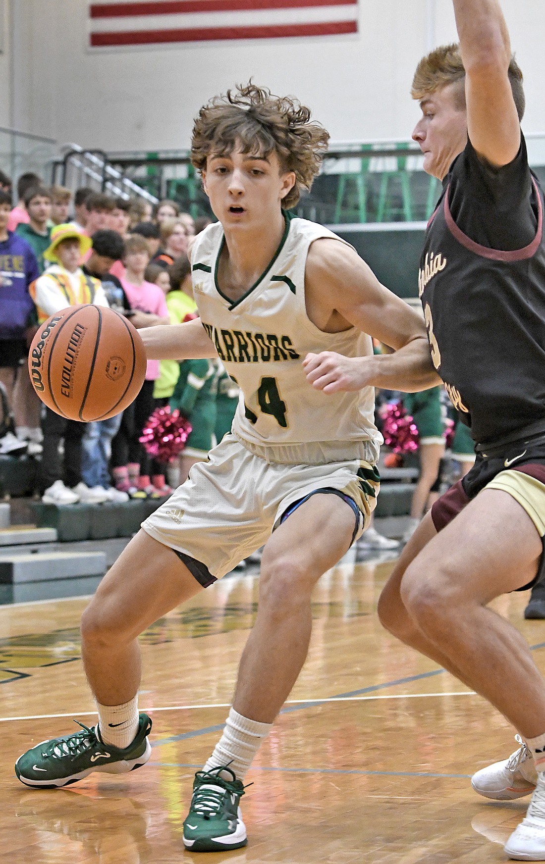 Sophomore Nolan Holzwart of Wawasee works his way to the basket as Stratton Fuller of Columbia City defends. Photo by Gary Nieter