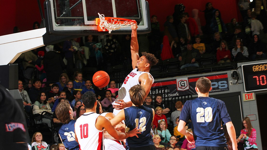 Grace’s Elijah Malone throws down a thundering dunk.