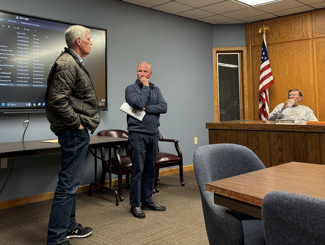 Indiana state Rep. David Abbott (L) and Kosciusko Economic Development Corporation Project Director Terry Sweeney address the Syracuse Council Tuesday regarding an impact study for South Shore Development. Council Member Bill Musser is shown seated. Photo by Denise Fedorow